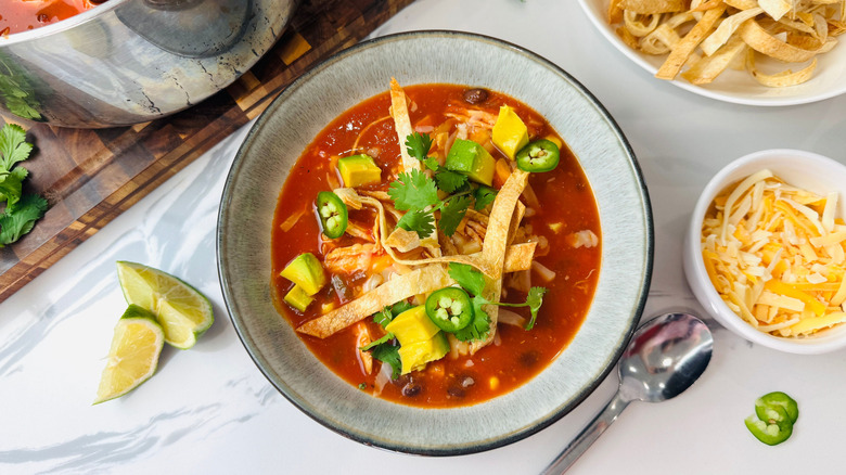 Bowl of chicken tortilla soup with toppings