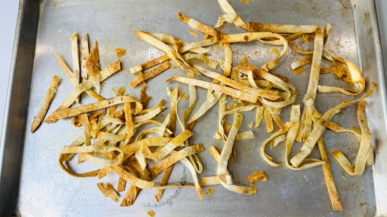 Baked tortilla strips on baking sheet