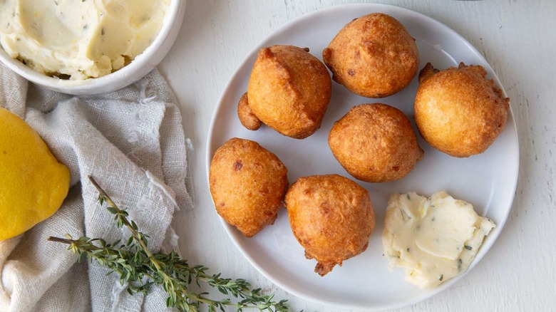 fried hush puppies on plate with lemon honey butter