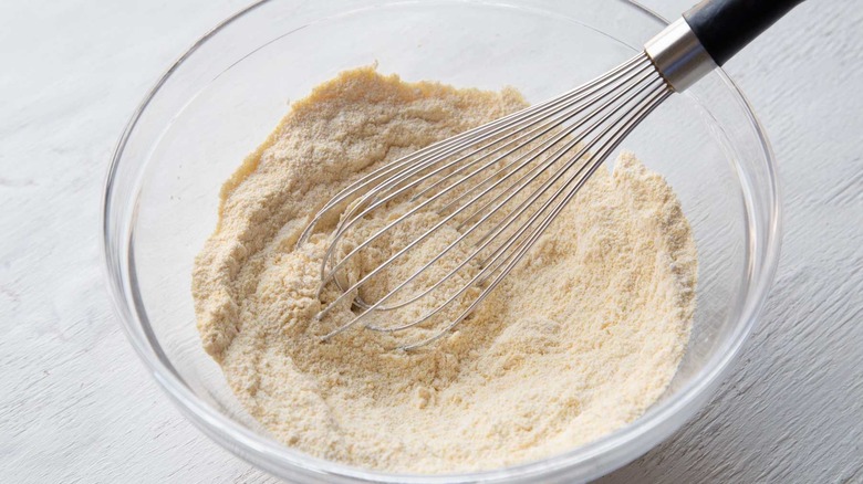 whisking flour, cornmeal, and leavening agents in bowl