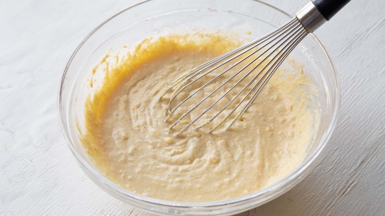 whisking hush puppies batter in bowl