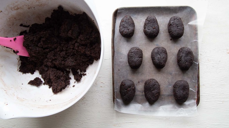 egg-shaped chocolate cake on a paper-lined pan