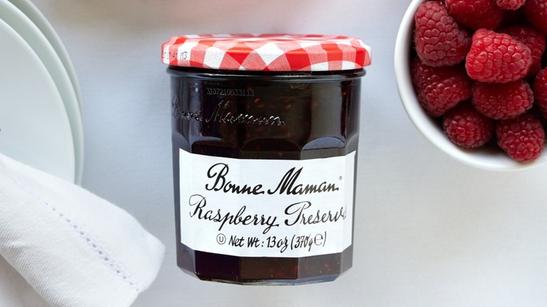 Bonne Maman Raspberry Preserves alongside fresh raspberries