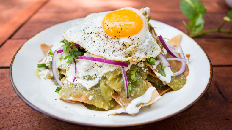 Chilaquiles with salsa verde, onions, and a fried egg