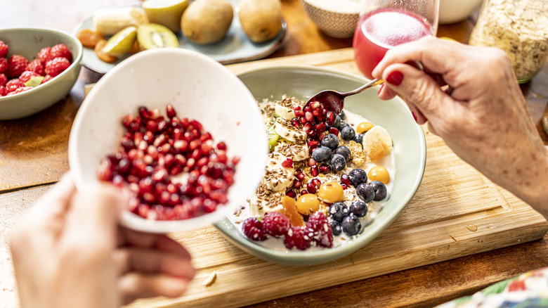 Adding fruit to a bowl of cereal