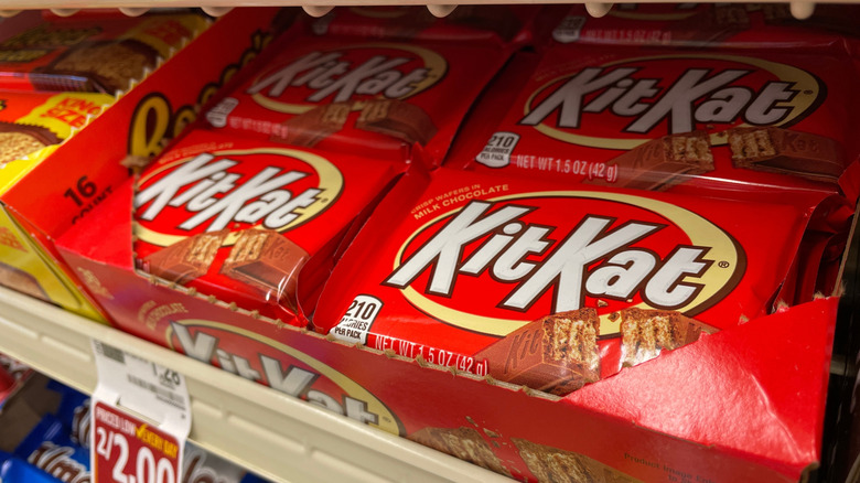 Kit Kat bars in a box on a grocery store shelf.