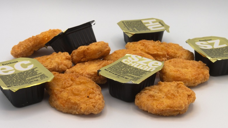 A number of McNuggets, alongside Szechuan dipping sauce.