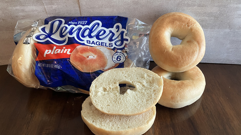 Lender's Bagels on table with package and one sliced in half.