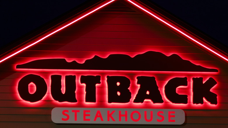 Outback Steakhouse red neon sign at night