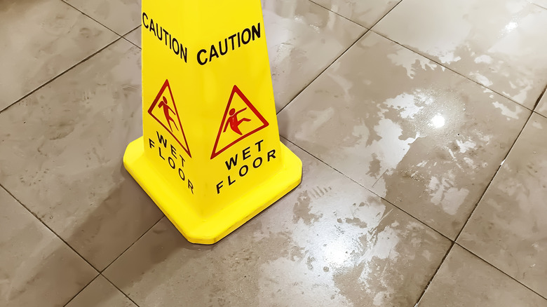 A caution sign on a wet floor.
