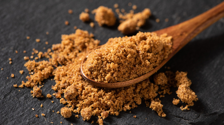 Closeup of brown sugar in a wooden spoon