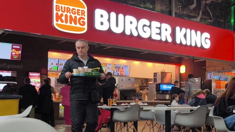 Person walking with tray of food from Burger King