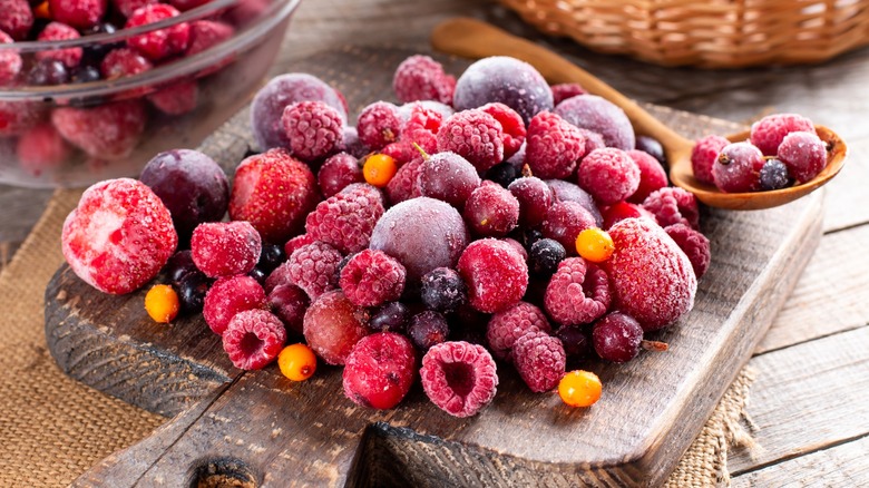 Frozen berries on wood board