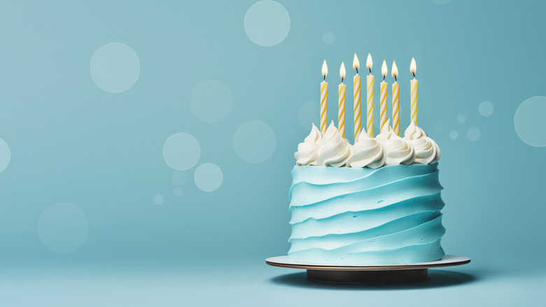 A birthday cake with frosting on an abstract background