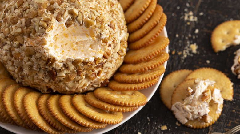 Classic cheese ball covered in nuts and served with crackers