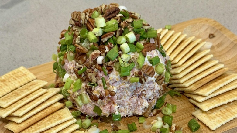 Ham and cheese ball with pecans, green onions, and crackers