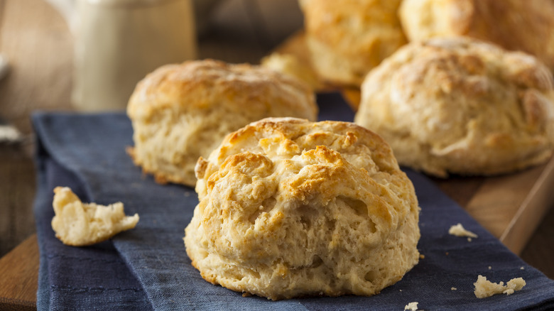 Flaky buttermilk biscuits on a blue kitchen towel