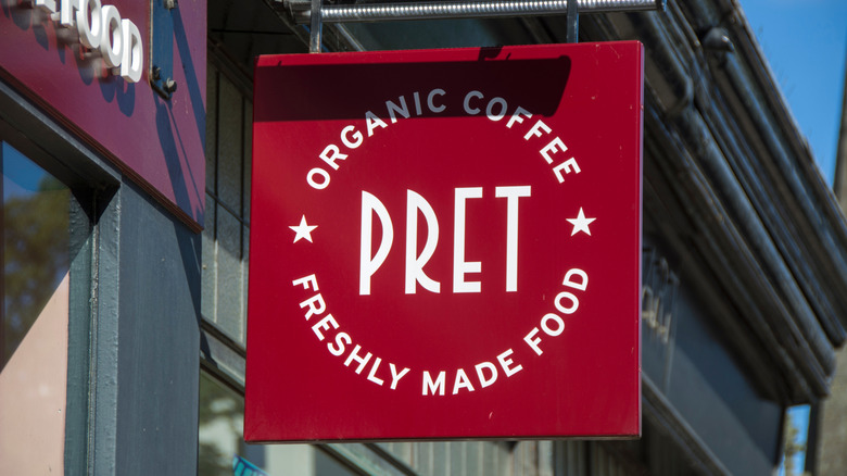A red Pret sign outside of a Pret A Manager location during the daytime