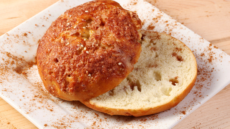A cinnamon bagel cut in half on a white napkin