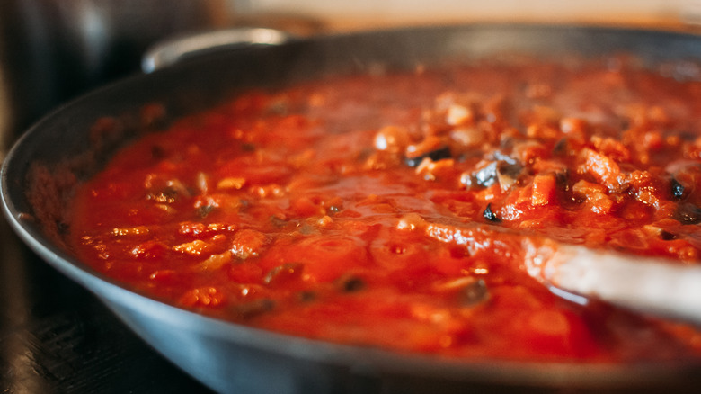 Homemade tomato sauce simmering in a pan