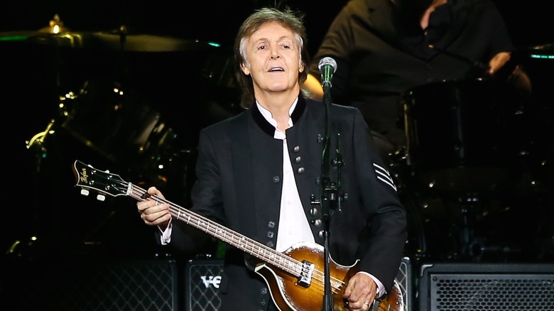 Paul McCartney performing on stage.