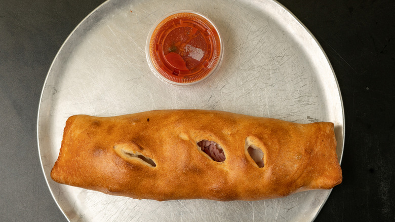 stromboli on a tray with with marinara sauce