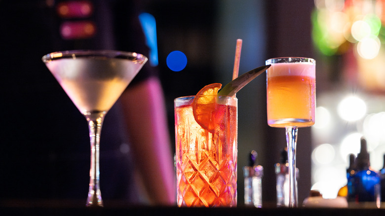 Three cocktails sitting on bar