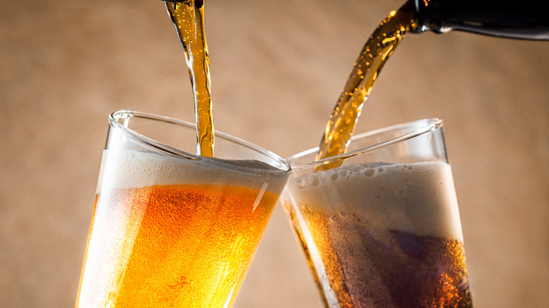 two different kinds of beers poured into cups