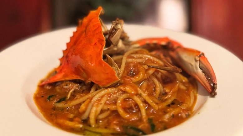 spaghetti with blue crab on a white plate