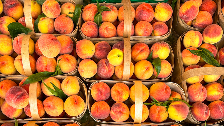 Perfectly ripe peaches in rustic baskets