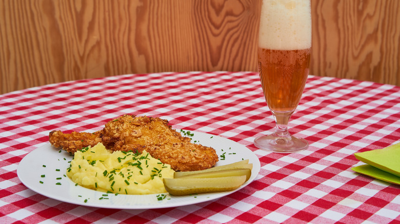 Fried chicken with pickles, potato salad, and beer