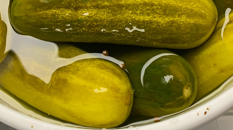 Whole, kosher dill pickles in a bucket