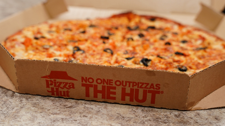 A Pizza Hut pizza in a box with the logo visible