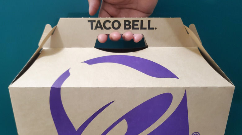 hand holding taco bell box