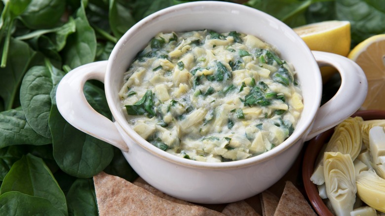 Spinach and artichoke dip in white bowl