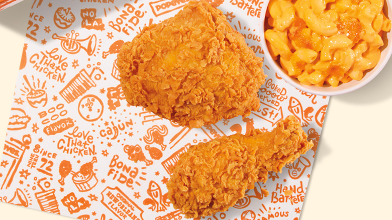 Pieces of Popeyes fried chicken and cup of mac and cheese