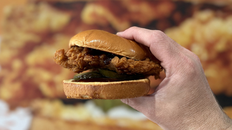 Popeyes' Honey BBQ Chicken Sandwich in hand