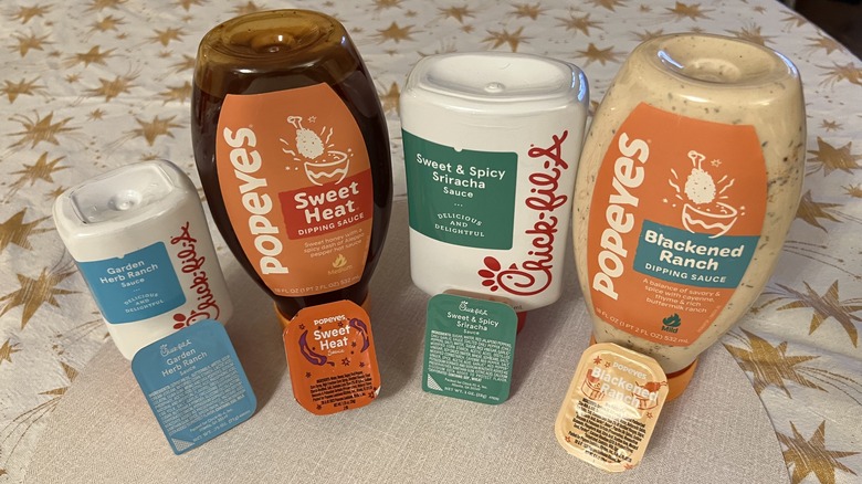 Popeyes and Chick-fil-A bottles and sauce cups