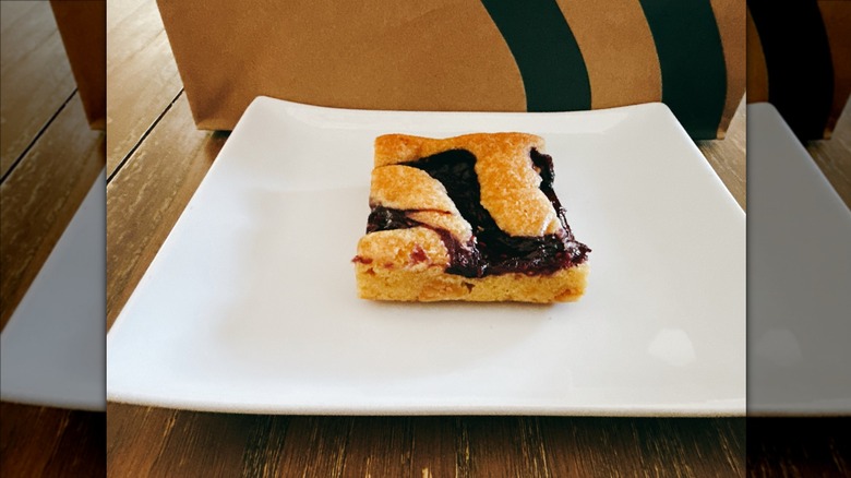 Starbucks  Berry Blondie on a white plate with Starbucks bag in the background