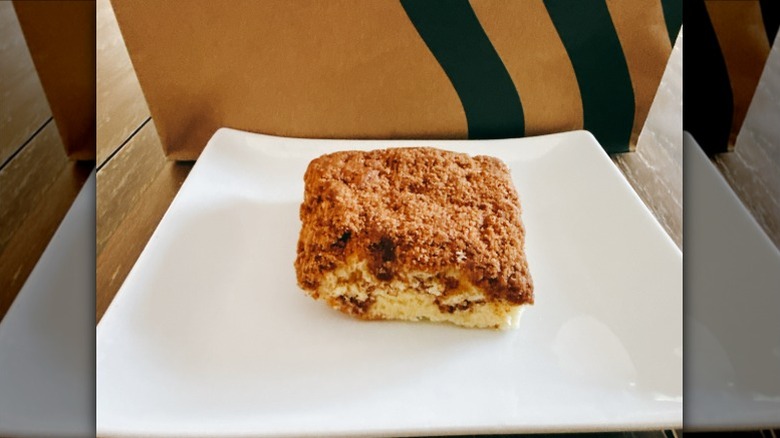 Starbucks Cinnamon Coffee Cake on a white plate with Starbucks bag in the background