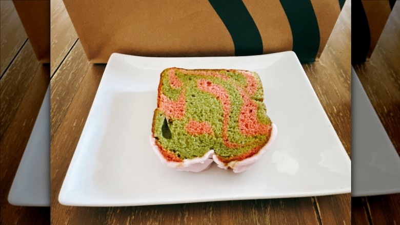 Starbucks Strawberry Matcha Loaf on a white plate with Starbucks bag in the background
