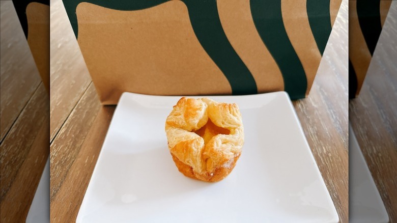 Starbucks Yuzu Citrus Blossom on a white plate with Starbucks bag in the background