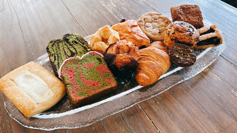 Variety of Starbucks bakery items on a glass serving tray on a wooden table