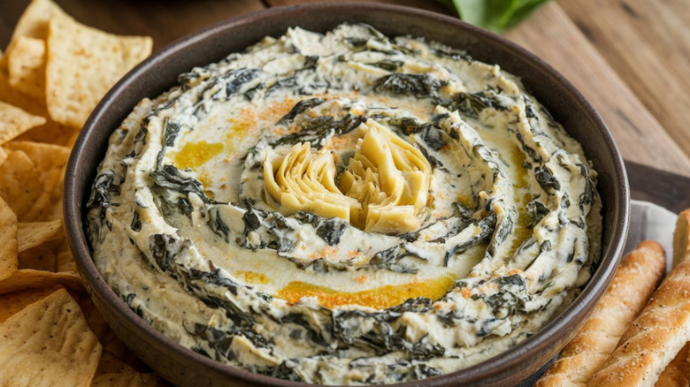 Artichoke dip served with chips and breadsticks