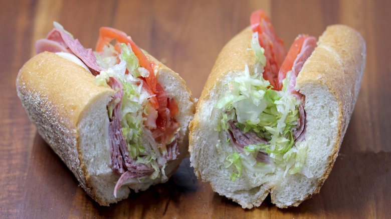 a Wawa Italian hoagie sliced in half on a wooden surface