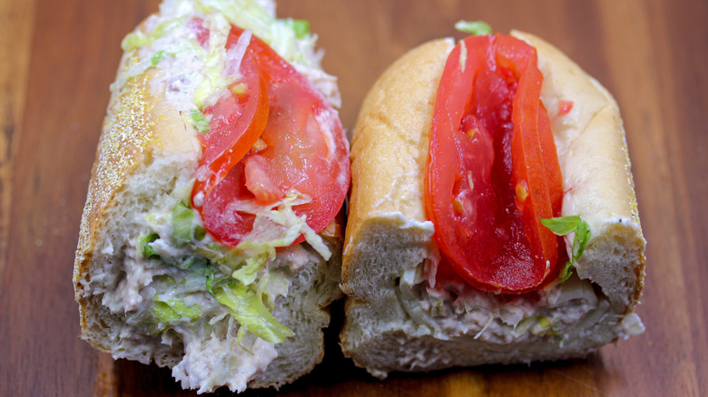a Wawa tuna hoagie with lettuce and tomato sliced in half