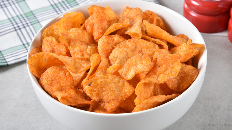 White bowl of barbecue chips on table
