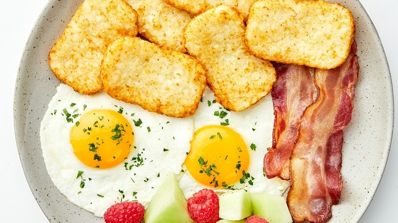 Plate of breakfast with hash browns and eggs