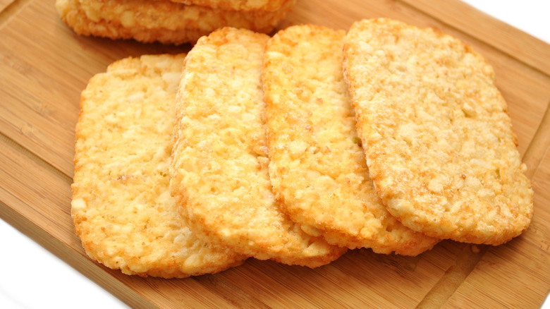 Frozen hash browns on wooden chopping board