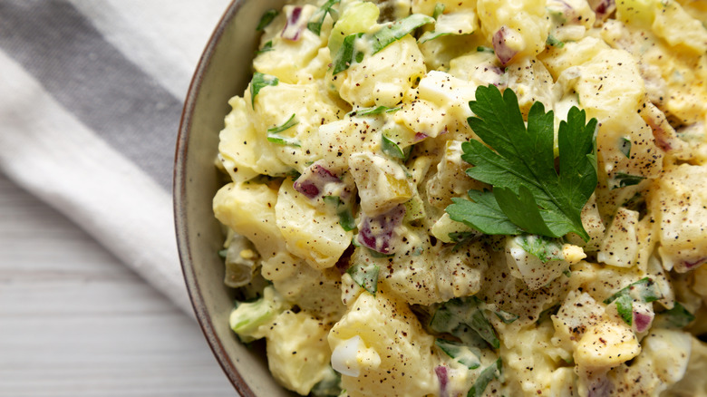 Close up of bowl of potato salad with parsley